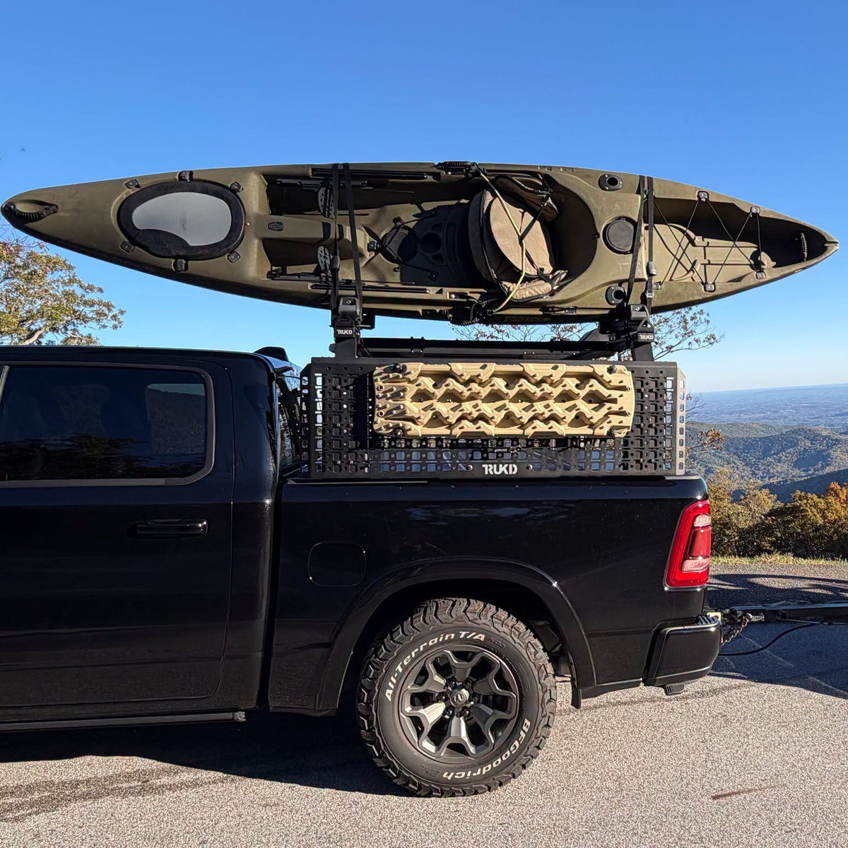 TRUKD V2 18.5" Accessory Panel with traction boards mounted, on a TRUKD bed rack on a full-size pickup with a kayak on top